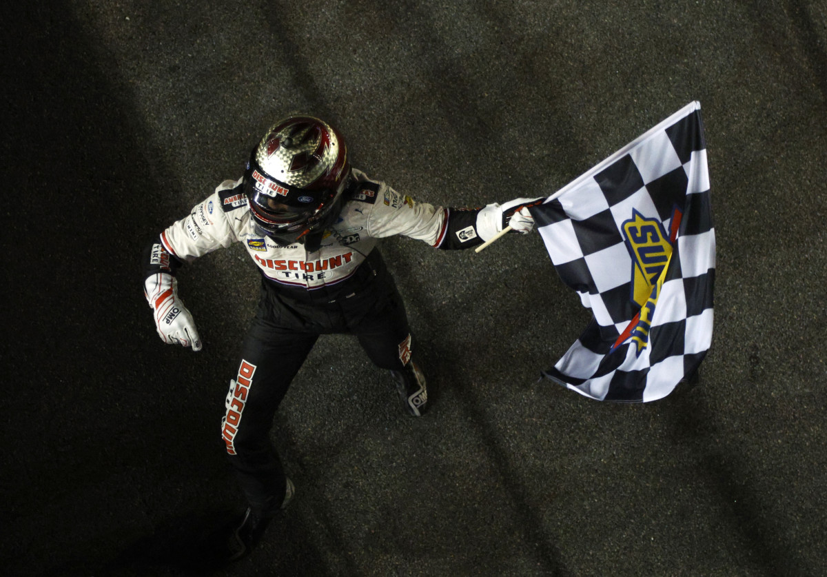 Austin Cindric makes it official, taking the checkered flag after winning the 64th Daytona 500 on Sunday. (Photo by Sean Gardner/Getty Images)